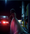 Woman in wedding dress pumping gas.